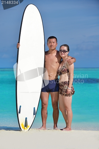 Image of happy young  couple enjoying summer on beach