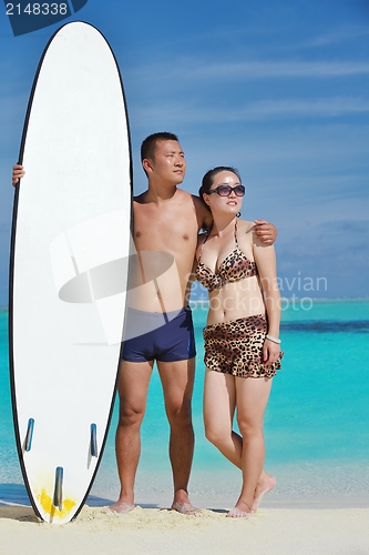 Image of happy young  couple enjoying summer on beach