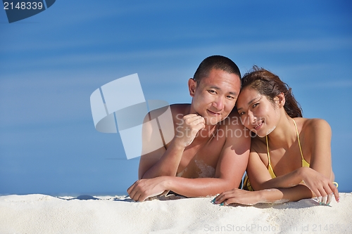 Image of happy young  couple enjoying summer on beach