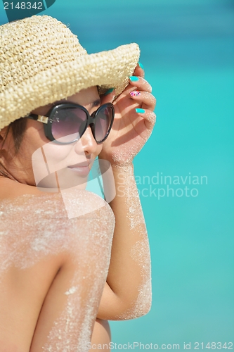 Image of beautiful  woman resting on tropical  beach