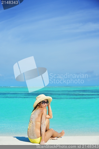 Image of beautiful  woman resting on tropical  beach