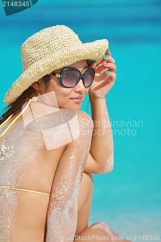 Image of beautiful  woman resting on tropical  beach