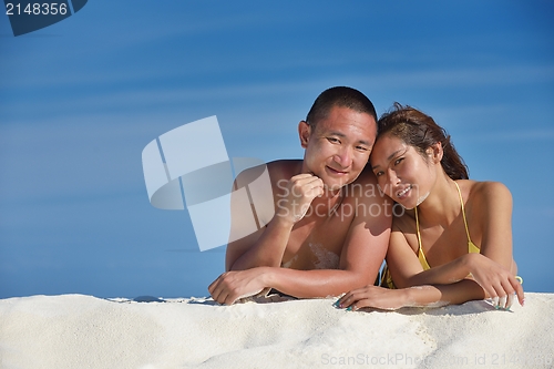 Image of happy young  couple enjoying summer on beach