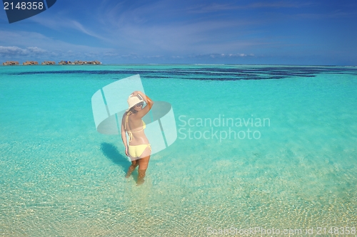 Image of beautiful  woman resting on tropical  beach