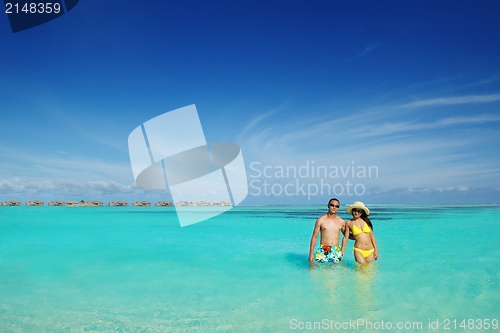 Image of happy young  couple enjoying summer on beach