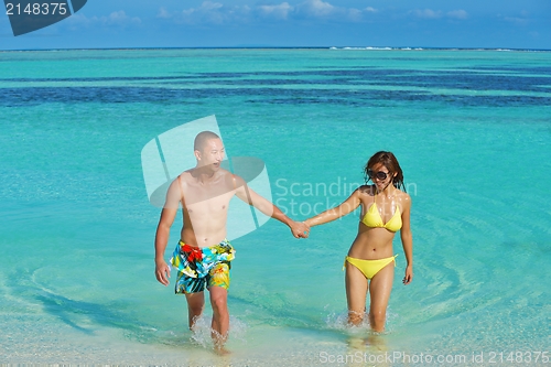 Image of happy young  couple enjoying summer on beach