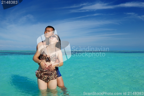 Image of happy young  couple enjoying summer on beach