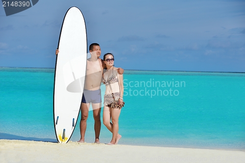 Image of happy young  couple enjoying summer on beach