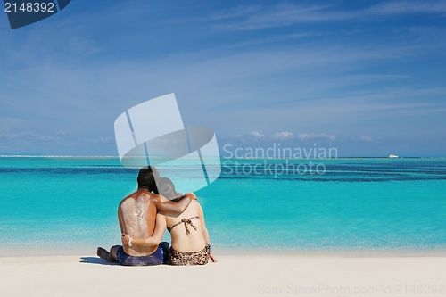 Image of happy young  couple enjoying summer on beach