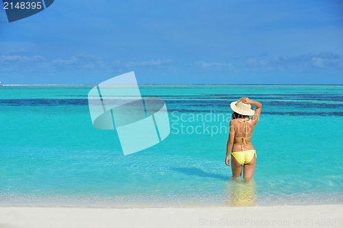 Image of beautiful  woman resting on tropical  beach