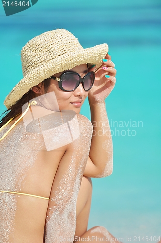 Image of beautiful  woman resting on tropical  beach