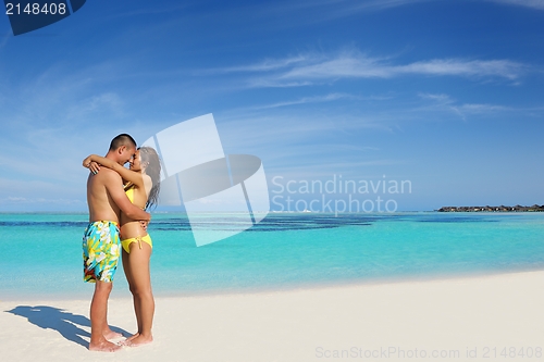 Image of happy young  couple enjoying summer on beach