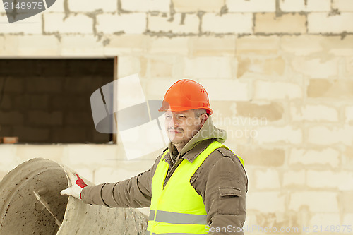 Image of Builder at the new building near the concrete mixer