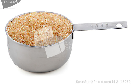 Image of Demerara sugar presented in an American metal cup measure