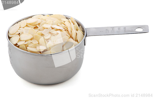 Image of Flaked almonds presented in an American metal cup measure