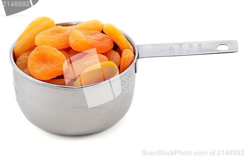 Image of Whole dried apricots presented in an American metal cup measure