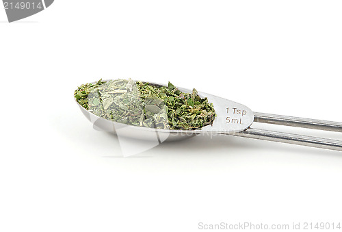 Image of Mixed herbs measured in a metal teaspoon