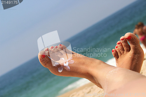 Image of Female feet on the beach