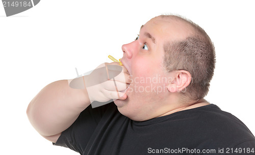 Image of Fat Man Greedily Eating French Fries