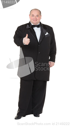 Image of Elegant fat man in a tuxedo shows thumb-up