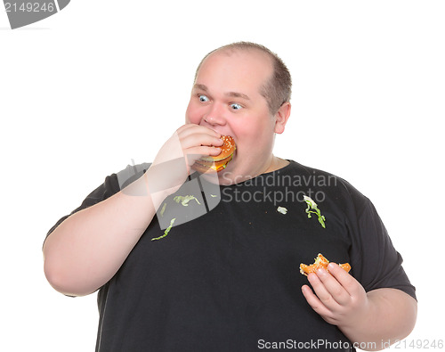 Image of Fat Man Greedily Eating Hamburger