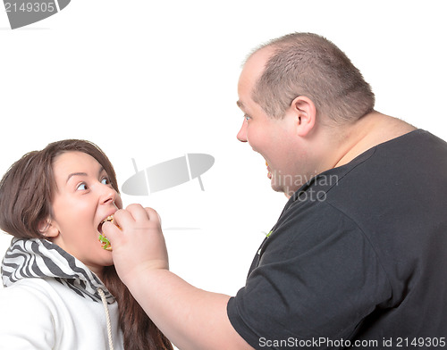 Image of Fat Man Feeding a Girl a Burger