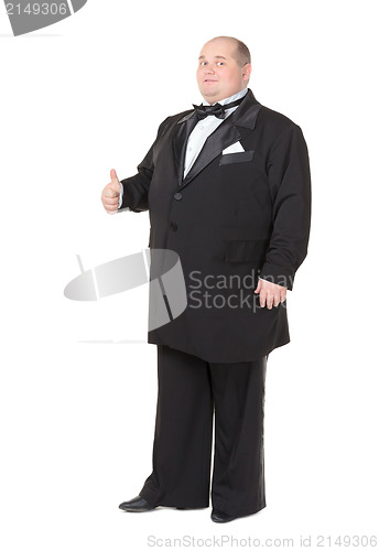 Image of Elegant fat man in a tuxedo shows thumb-up