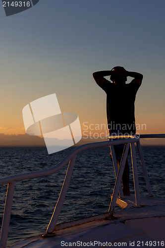 Image of Person enjoying an ocean sunset