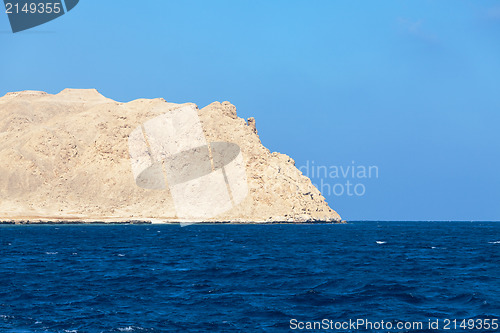 Image of Sea with stony bare mountain in the background