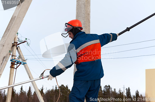 Image of Electrician working on power lines