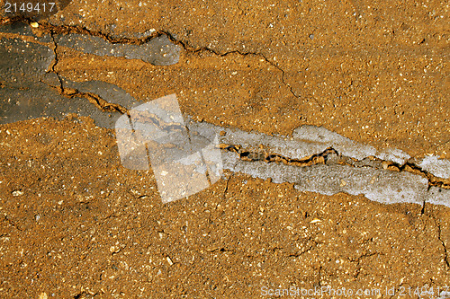 Image of Close-Up Rural Road Surface Cracks and Breaking Up