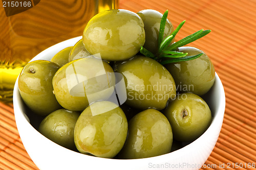 Image of Green olives in a white ceramic bowl