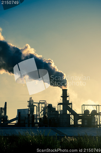 Image of Smoking chimney  at sunset 