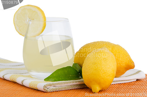 Image of Cup of lemon juice and fresh lemons