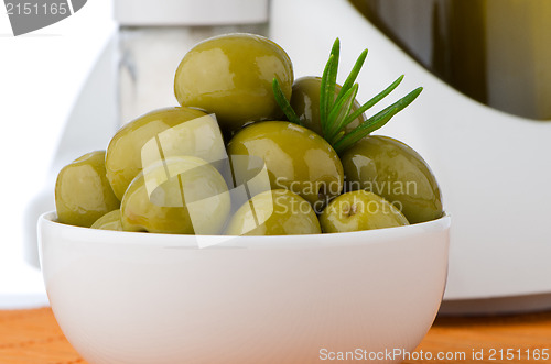 Image of Green olives in a white ceramic bowl