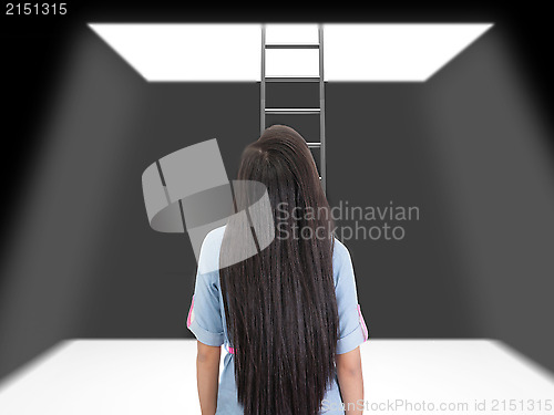 Image of woman standing in a pit looking up to the ladder that leads out 