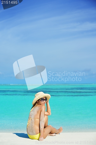 Image of beautiful  woman resting on tropical  beach