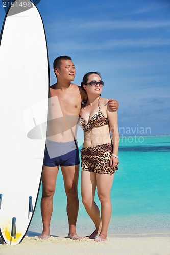 Image of happy young  couple enjoying summer on beach