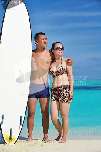 Image of happy young  couple enjoying summer on beach