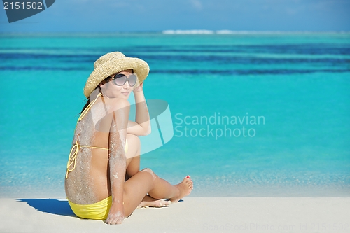 Image of beautiful  woman resting on tropical  beach