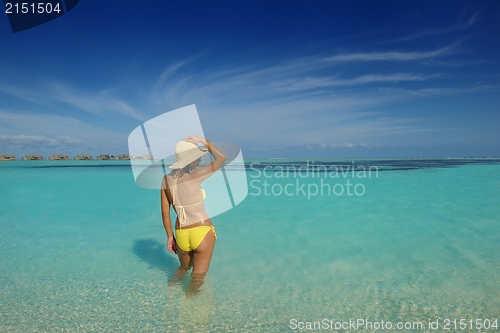 Image of beautiful  woman resting on tropical  beach