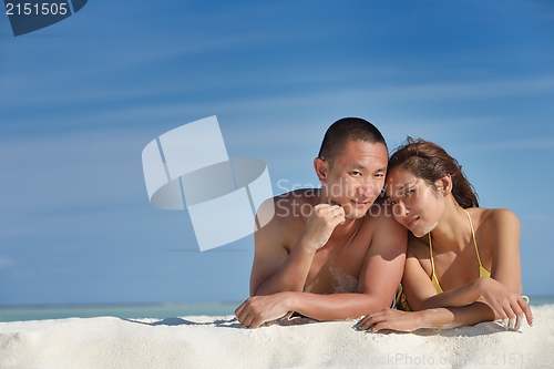 Image of happy young  couple enjoying summer on beach