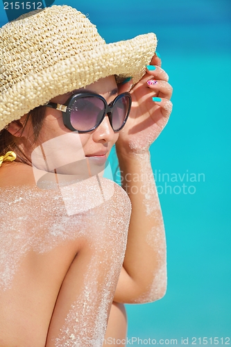 Image of beautiful  woman resting on tropical  beach