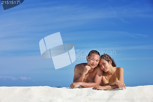 Image of happy young  couple enjoying summer on beach