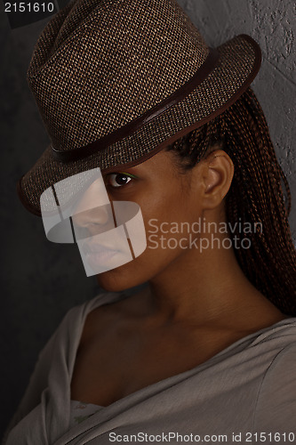 Image of dark portrait of a girl in hat