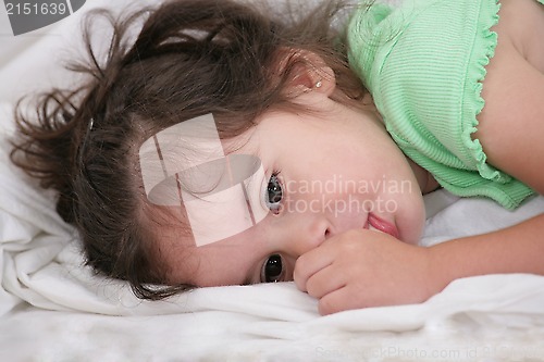 Image of small child holding a finger in his mouth. studio photos. Close-