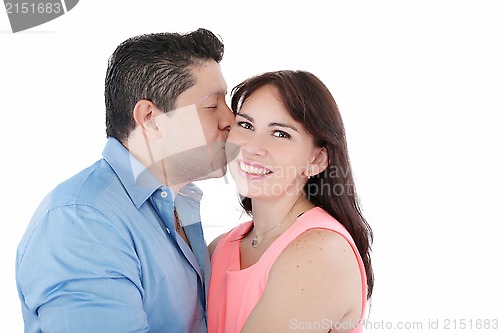 Image of Close-up portrait of woman being affectionately kissed by her hu