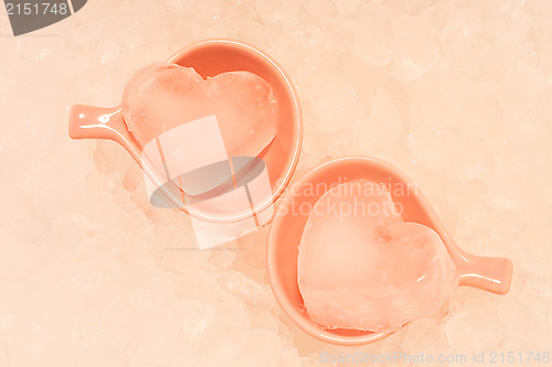 Image of Heart ice in pink cups with ice texture background