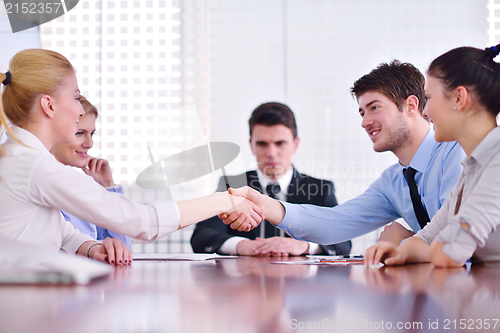 Image of business people making a deal at meeting