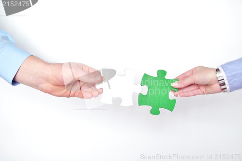 Image of Group of business people assembling jigsaw puzzle